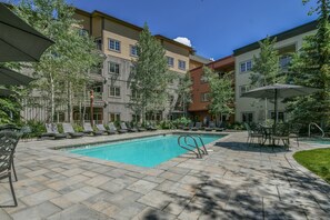 Relax by the pool surrounded by comfortable lounge chairs and a dining area.
