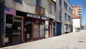 A storefront with a sign reading "AMERICAN MARKET" and "PRODUITS AMERICAN." - THE SQUARE ROOT (Dijon)