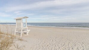 A beach with a lifeguard stand marked with the number 13. - Blue Heaven - Walk to Beach & Boardwalk, Ocean and Sunset Views, Dog-Friendly (Carolina Beach)