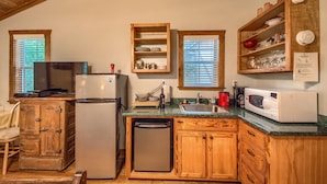 A compact kitchen with wooden cabinets, a refrigerator, a microwave, and a sink. - 1 mile to downtown - Short Drive - Jacuzzi Bath (Fredericksburg)