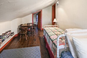 A compact room with a bed, a desk, and a chair. There is a bookshelf with books and a lamp on the desk. - Swimming - Fishing - Kayak - Near Fredericksburg, TX (Llano)