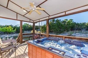 A hot tub area with a wooden deck, a ceiling fan, and bicycles leaning against the railing. - Private Hot Tub - Fireplace - 4 min. to downtown - Wildlife (Fredericksburg)