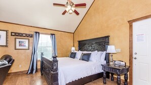 A bedroom with a wooden bed, a nightstand, a ceiling fan, and a door with a 'Please Read' sign. - Private Hot Tub - Fireplace - 4 min. to downtown - Wildlife (Fredericksburg)