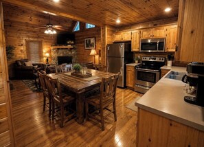 A wooden interior with a dining area, kitchen, and seating space.