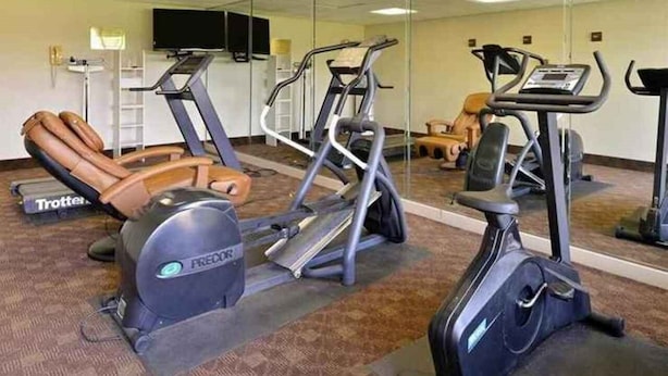 A gym with treadmills, an elliptical, and a stationary bike. - Heritage Inn & Suites by Capital O Baton Rouge I 10 (Baton Rouge)