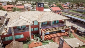 A hotel with multiple buildings, a prominent sign, and a view of the surrounding area. - Pier Beach Hotel (Cabo Frio)