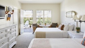 A hotel room with a bed, a desk, a chair, and a small table. There is a window with blinds, a plant, and a wall-mounted mirror. - Laguna Beach House (Laguna Beach)