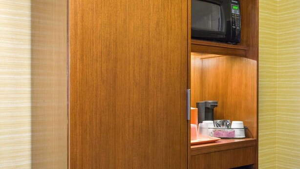 A compact kitchenette with a microwave, coffee maker, and a mini-fridge. - Fairfield Inn Suites By Marriott Paramus (Paramus)