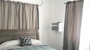 A bedroom with a bed, a ceiling fan, and curtains. - La Casita Verde in Cupey - Villa with Pool-Hot Tub and POWER GENERATOR (San Juan)