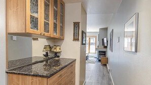 A kitchen with wooden cabinets, granite countertop, and a small island with a sink. - ⭐️New Listing ⭐️ At Purg Base ⎮Free WIFI + Fireplace (Durango)