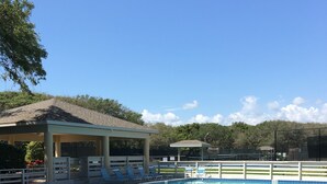 A swimming pool with lounge chairs and a covered pavilion. - 250 Sea Woods - 3BD - Your Beach Escape Awaits (New Smyrna Beach)
