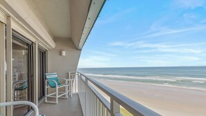 A balcony with a view of the beach.