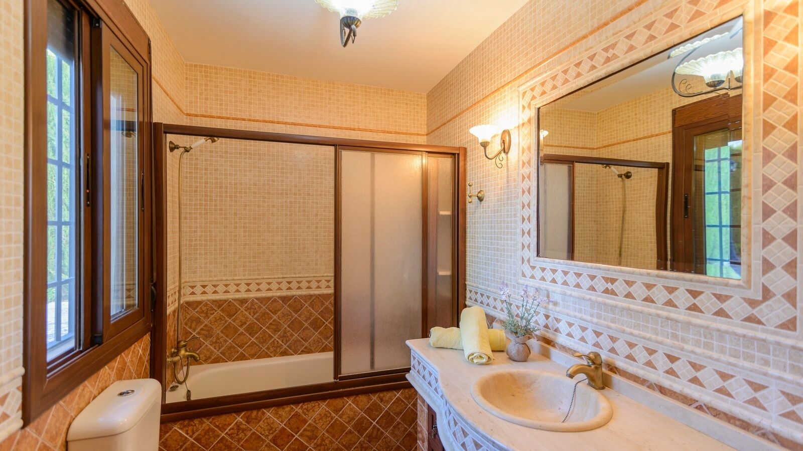A bathroom with a bathtub, a sink, a mirror, and a shower.