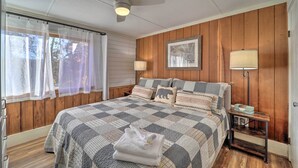 A bedroom with a bed, a ceiling fan, a bedside table with a lamp, and a window with sheer curtains. - < 1 Mi to Beech Mtn Ski! Condo w/ Hot Tub Access (Beech Mountain)
