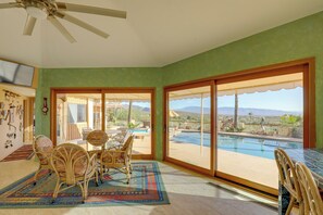 Enjoy a scenic view of the surrounding landscape from the comfort of your room, which features a dining area and a ceiling fan.