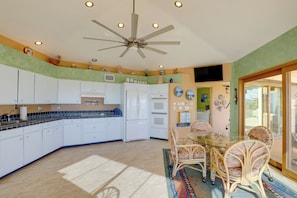 Enjoy cooking in this well-equipped kitchen with a central island, refrigerator, and oven.