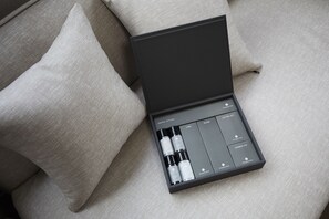 A black box with a dental kit and a shower cap on a beige fabric surface. - Sokcho Chonpines Beach Hotel (Sokcho)