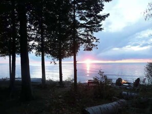 A sunset view with trees and chairs by the water. - Waterfront, Dog Friendly Sherwood Point (Sturgeon Bay)