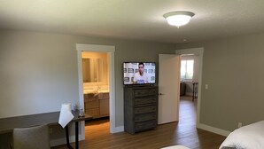 A hotel room with a bed, a desk, a chair, a television, and a kitchenette. - Perfect for Long Stays. Recently remodeled townhouse next to Freeway & C of I.  (Caldwell)