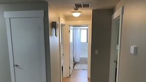 A hallway with wooden flooring, white walls, and a door on the left. - Perfect for Long Stays. Recently remodeled townhouse next to Freeway & C of I.  (Caldwell)