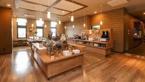 A modern kitchen with wooden countertops, stainless steel appliances, and pendant lighting. - Route Inn Grantia Tokai Spa & Relaxation (Tokai)