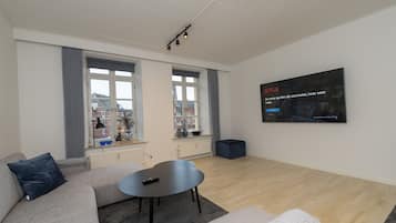 Luxury Apartment | Living room | 75-inch flat-screen TV with cable channels, TV