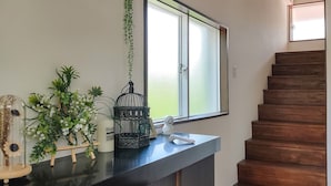 A staircase with wooden steps and a window above it. - Warayunso Villa (Naha)