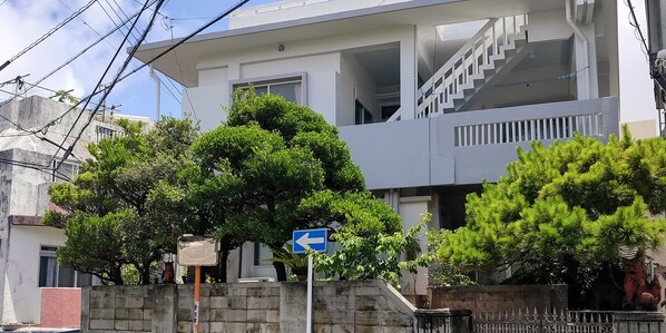 A modern two-story building with a staircase leading to the upper floor. - Warayunso Villa (Naha)