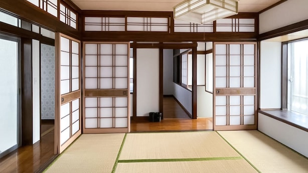 A traditional Japanese room with tatami flooring, shoji screens, and a wooden ceiling. - Warayunso Villa (Naha)