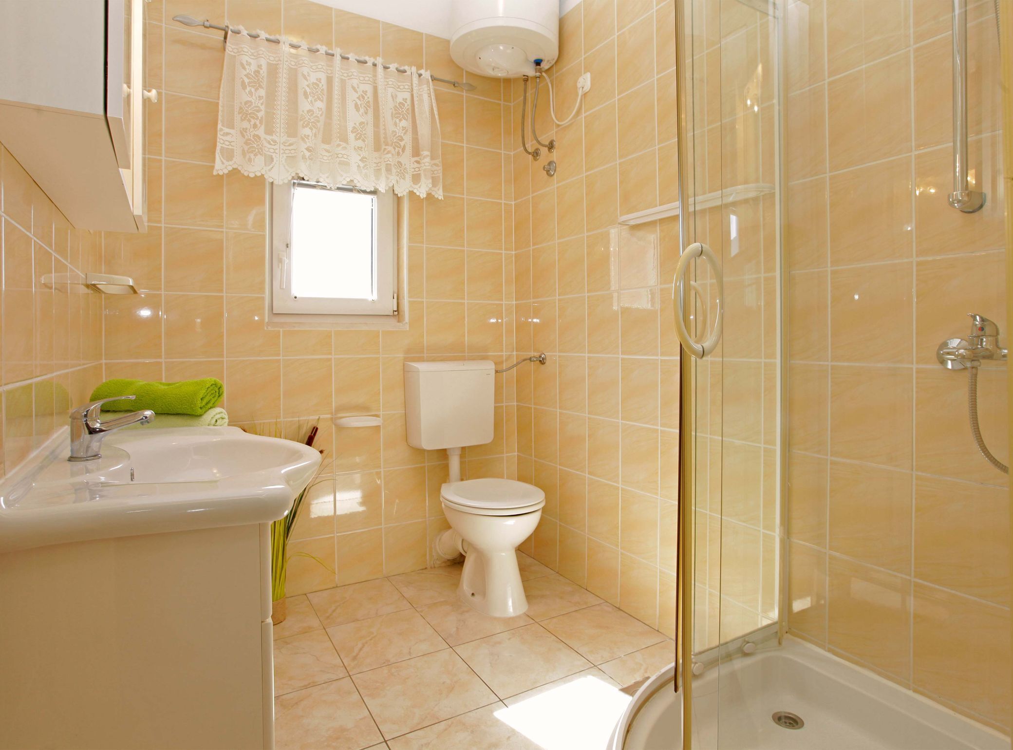 A bathroom with a sink, toilet, and shower.