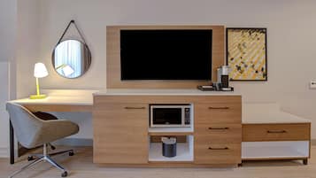 A modern bedroom with a bed, bedside table, and a large window.