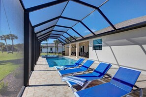 A heated pool, sun loungers