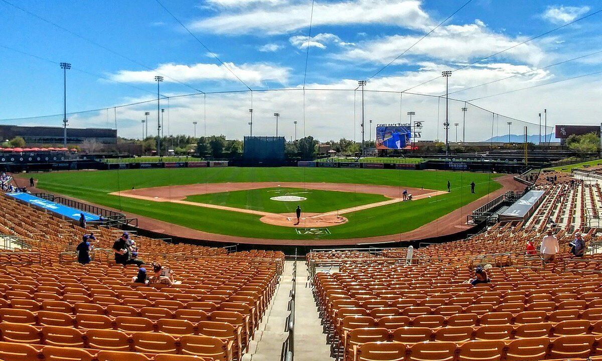 A baseball stadium with a large seating area, a central field, and a scoreboard.