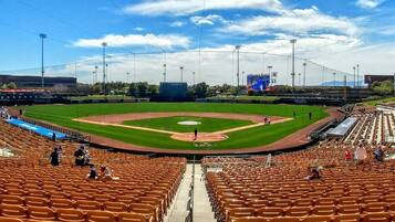 A baseball stadium with a large seating area, a central field, and a scoreboard.