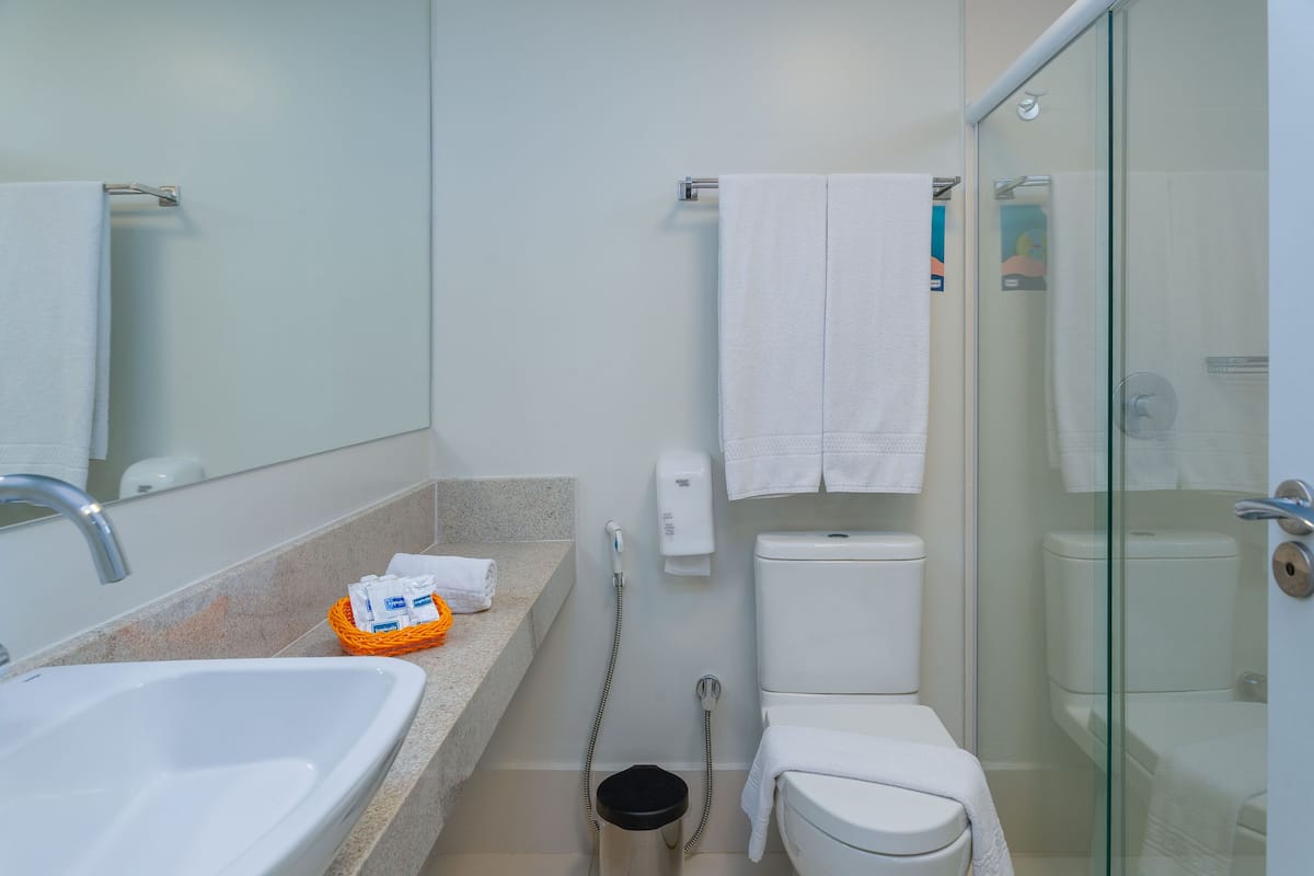 Ein modernes Badezimmer mit Waschbecken, Toilette und einer Duschkabine.