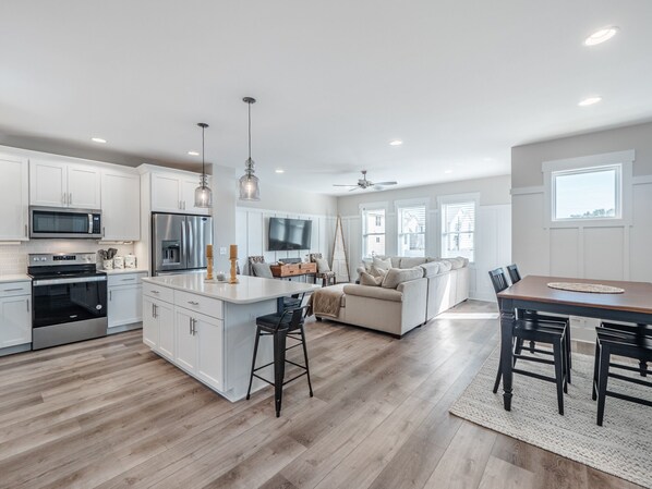 Enjoy cooking in this well-lit kitchen with a central island and stainless steel appliances.