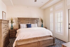 Classic bedroom with a large bed, nightstands, and a traditional design.