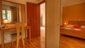 A room with a wooden desk, chair, and bed. - Apartment Villa Molina (Zupa dubrovacka)