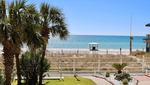A beach view with palm trees and a lifeguard tower. - 2nd Floor @ THE SUMMIT 1BR 1.5BA W/ BEACH CHAIRS INCLD. (Panama City Beach)