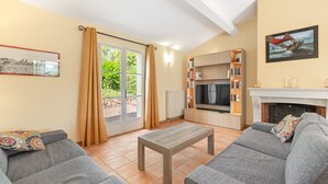 A living room with a sofa set, a coffee table, a TV, and a fireplace. - 3 BEDROOM VILLA WITH PRIVATE POOL AND GARDEN (N°355) (La Motte)