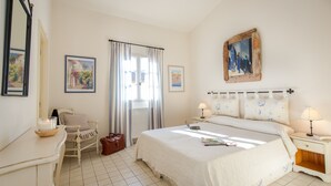 A bedroom with a bed, a chair, a desk, a lamp, and a window with curtains. - 2-BEDROOM APARTMENT WITH TERRACE (N°555) (La Motte)
