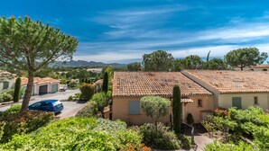 A residential area with houses, a parked car, and a clear blue sky. - 2 BEDROOM APARTMENT WITH TERRACE (N°513) (La Motte)