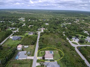 An aerial view of a residential area with houses, roads, and green spaces. - Endless Summer (Port Charlotte)