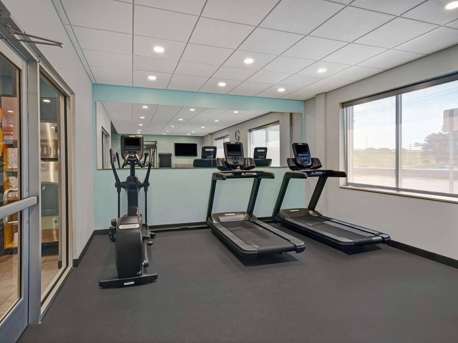 A gym with treadmills, a stationary bike, and a mirrored wall.