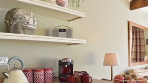 A kitchen with a kettle, coffee maker, mugs, and a basket of apples. - 2 bedroom accommodation in Sedgefield (Sedgefield)