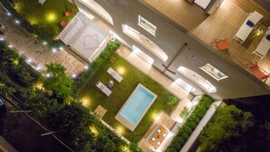 A rooftop pool area with a rectangular pool, surrounded by outdoor seating and a small garden. - Luxury Apartment with Penthouse and Pool (Sant'Agnello)