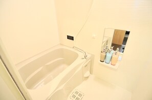 Bathroom features a bathtub and a minimalist design.
