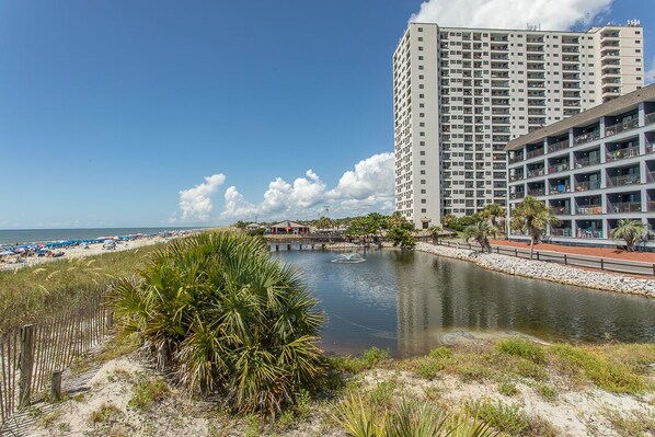 A coastal hotel with a view of the beach and a body of water.