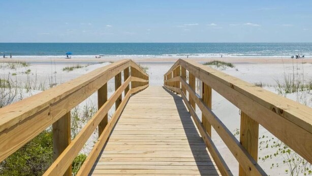 A wooden boardwalk leading to a beach with clear skies. - Ocean View Unit 3305 - Ocean & Racquet Resort [20% DISCOUNT ON 7+ NIGHT STAYS] (St. Augustine Beach)