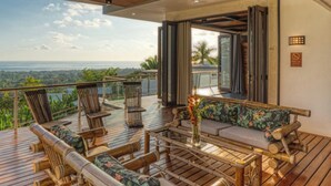 A wooden deck with outdoor furniture, a ceiling fan, and a view of the ocean. - Simply Spectacular Luxury Ocean View Villa!  (Uvita)